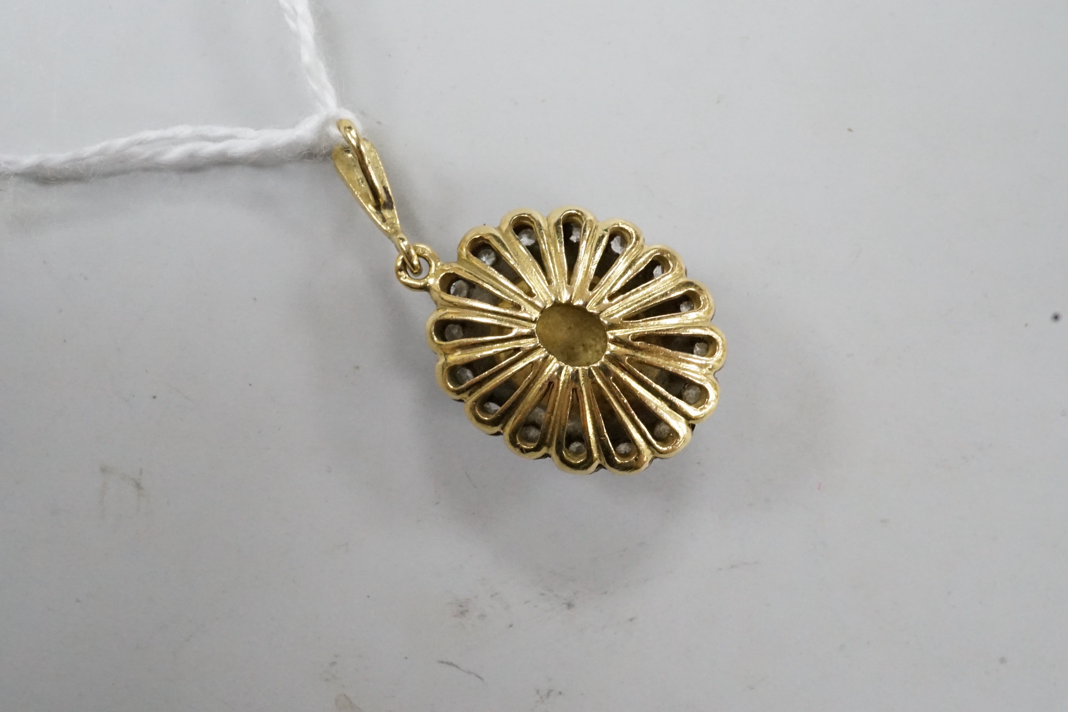 A modern 18ct gold, enamel and illusion set diamond chip oval cluster pendant, overall 30mm, gross weight 5.9 grams.